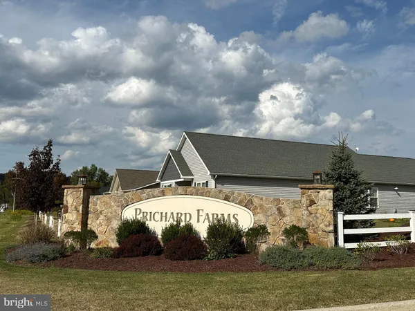 a black and white building with trees in the background
