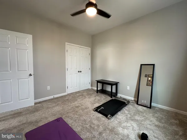 a room with gym equipment and a large window