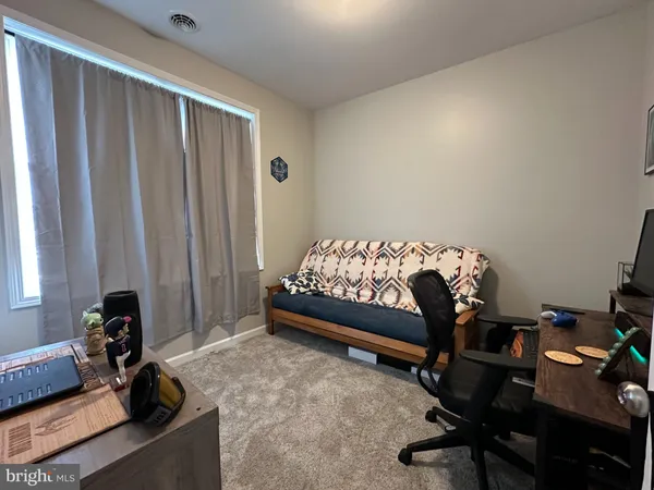 a bedroom with a bed and a desk