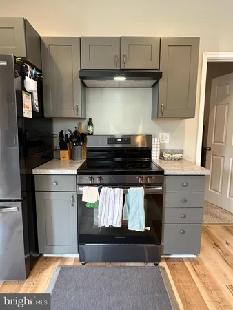 a kitchen with a stove and a refrigerator