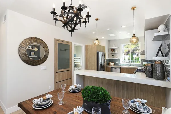 a kitchen with granite countertop a refrigerator and a sink