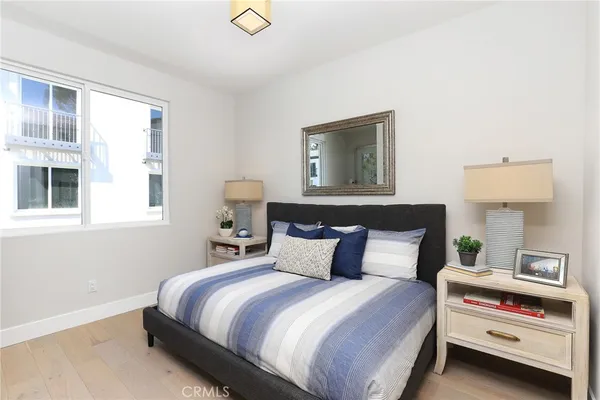 a bedroom with a large bed and a potted plant