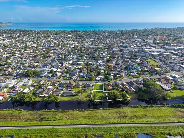 an aerial view of a house with a yard