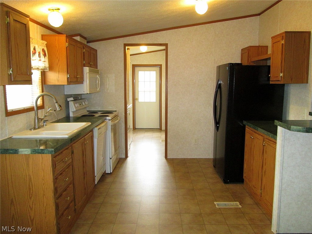 11248 Stratton Road West Salem, OH 44287 - Photo 4 of 12 The fully applianced, spatious kitchen. The laundry room is straight ahead.