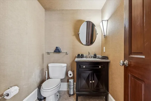 a bathroom with a toilet a sink and mirror