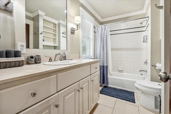 a bathroom with a double vanity sink toilet mirror and bathtub