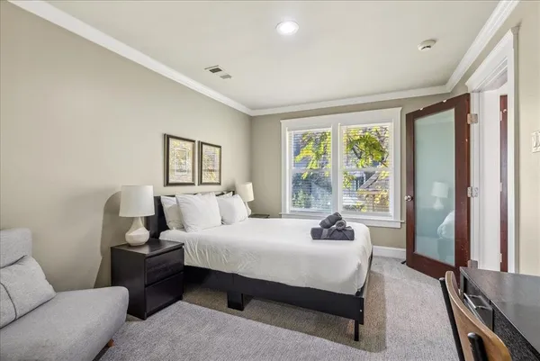 a bedroom with a bed couch and window