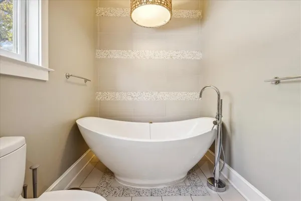 a white bath tub sitting in a bathroom