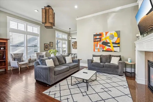a living room with fireplace furniture and a wooden floor