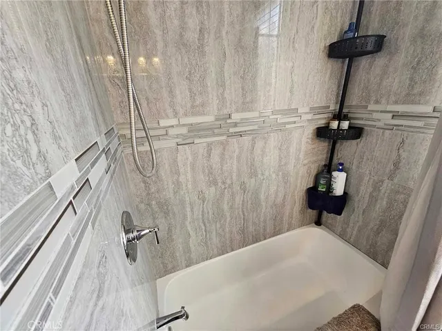 a bathroom with a sink mirror and a window