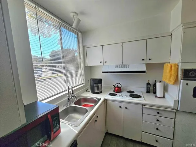 a kitchen with cabinets and a stainless steel appliances
