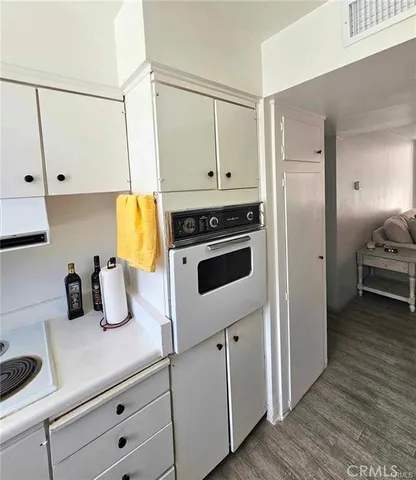 a view of a hallway with a door and wooden floor