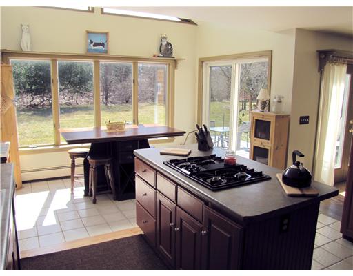 3 High Meadow Road Little Compton, RI 02837 - Photo 2 of 20 Kitchen. Kitchen with its gas range islandtop has a virtual wall of glass along the south side of the house (where the eating area is) with sliders as well, leading out to the back patio.