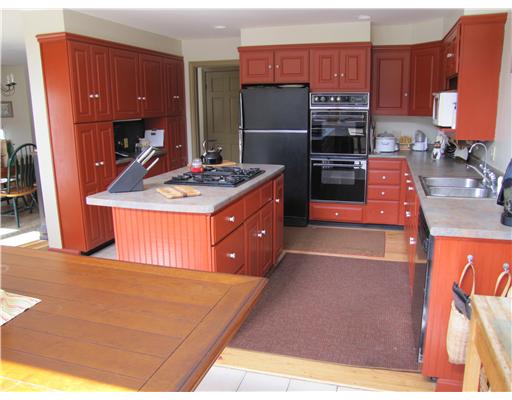 3 High Meadow Road Little Compton, RI 02837 - Photo 3 of 20 Kitchen. Taken from the eating area looking back into the working area of the kitchen. Very bright and sunny. Dining room located off to the left side.