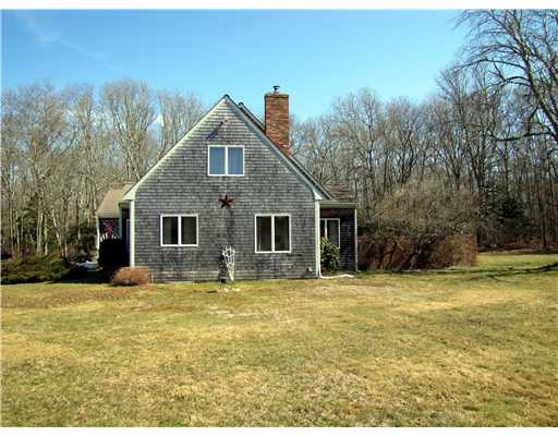 3 High Meadow Road Little Compton, RI 02837 - Photo 5 of 20 Exterior Back. This is a side yard view looking at the west side of the house. Most of the yard to the west, south is landscaped, while property to the north and east of the house is more forested .
