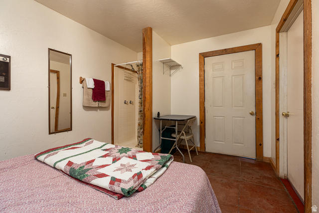 2040 North Long Cyn Road Kanab, UT 84741 - Photo 9 of 23 Bedroom featuring dark tile patterned floors