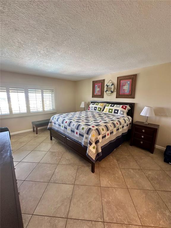 401 150th Avenue, Unit 266 Madeira Beach, FL 33708 - Photo 22 of 46 a bedroom with a bed and a couch