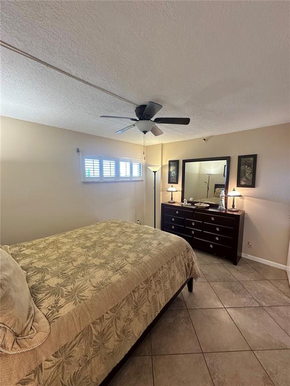 401 150th Avenue, Unit 266 Madeira Beach, FL 33708 - Photo 29 of 46 a bedroom with a bed and a flat screen tv