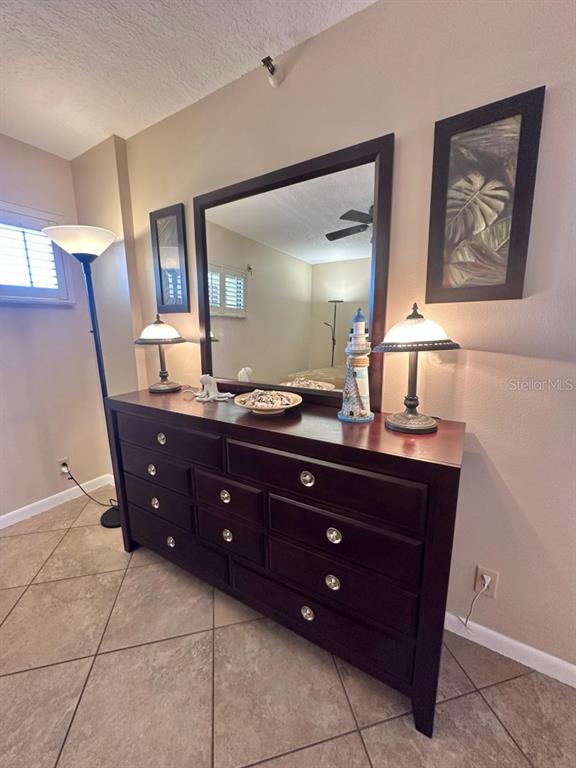 401 150th Avenue, Unit 266 Madeira Beach, FL 33708 - Photo 30 of 46 a bathroom with a granite countertop sink a mirror and a vanity