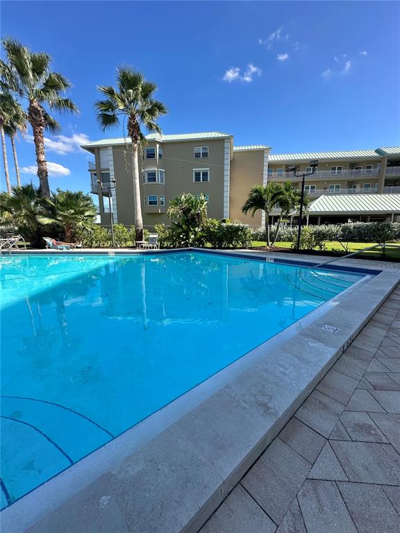 401 150th Avenue, Unit 266 Madeira Beach, FL 33708 - Photo 9 of 46 a view of a house with a swimming pool