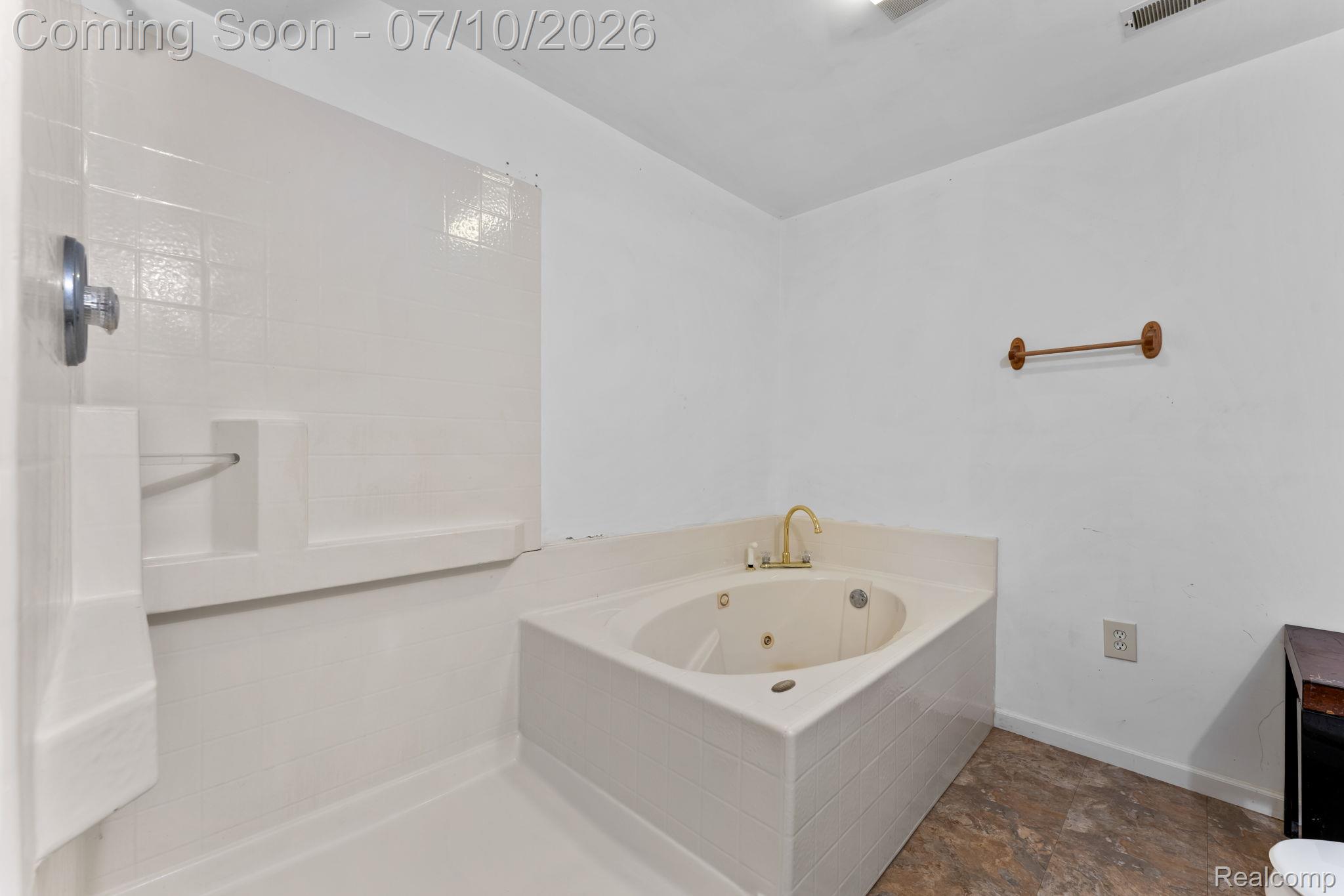 3144 North Nicholson Road Fowlerville, MI 48836 - Photo 70 of 70 Bathroom featuring a corner jetted tub, a separate shower with white tile surround, and wood-finish flooring