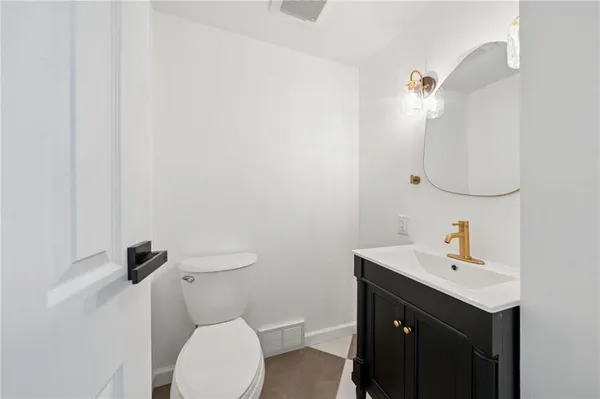 a bathroom with a sink a toilet and mirror