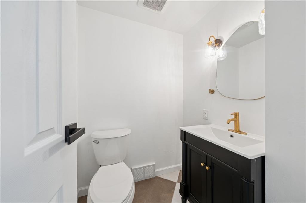 1714 O'Block Road Pittsburgh, PA 15239 - Photo 16 of 36 a bathroom with a sink a toilet and mirror