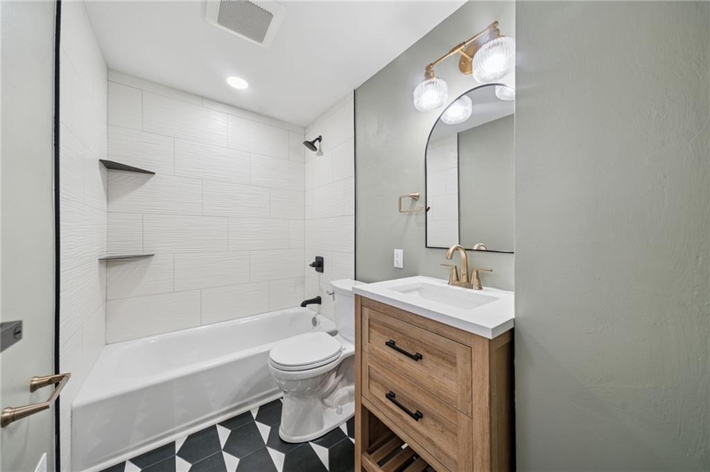 1714 O'Block Road Pittsburgh, PA 15239 - Photo 17 of 36 a bathroom with a sink a toilet a mirror and bathtub