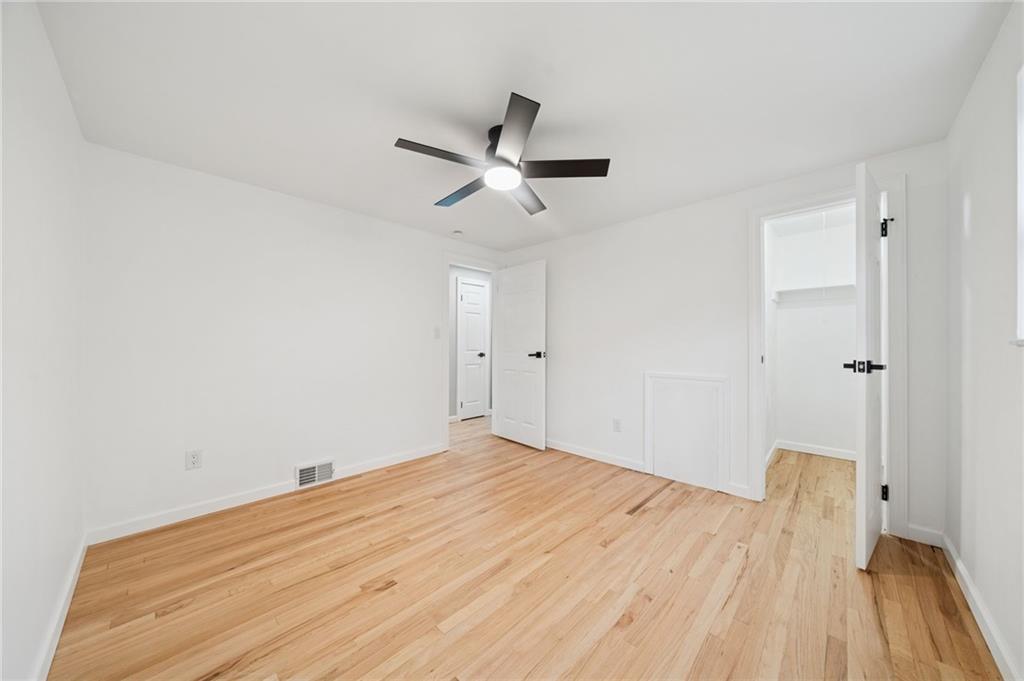 1714 O'Block Road Pittsburgh, PA 15239 - Photo 19 of 36 a view of a room with wooden floor and a ceiling fan