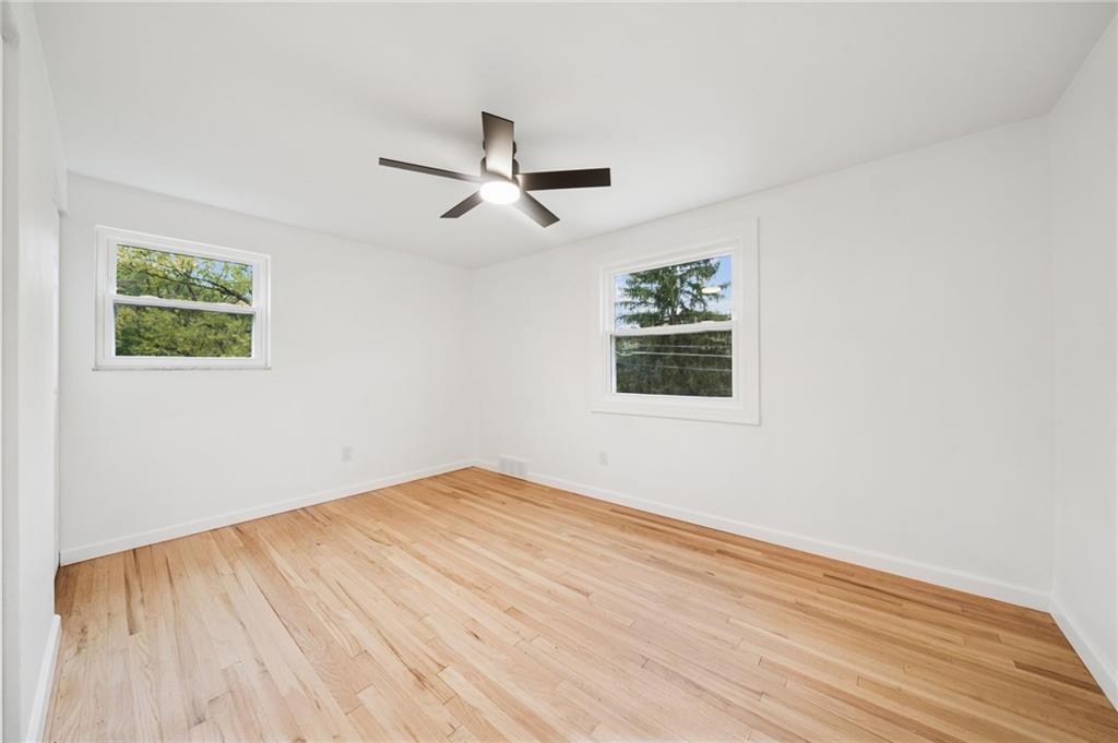 1714 O'Block Road Pittsburgh, PA 15239 - Photo 22 of 36 a view of empty room with wooden floor and fan