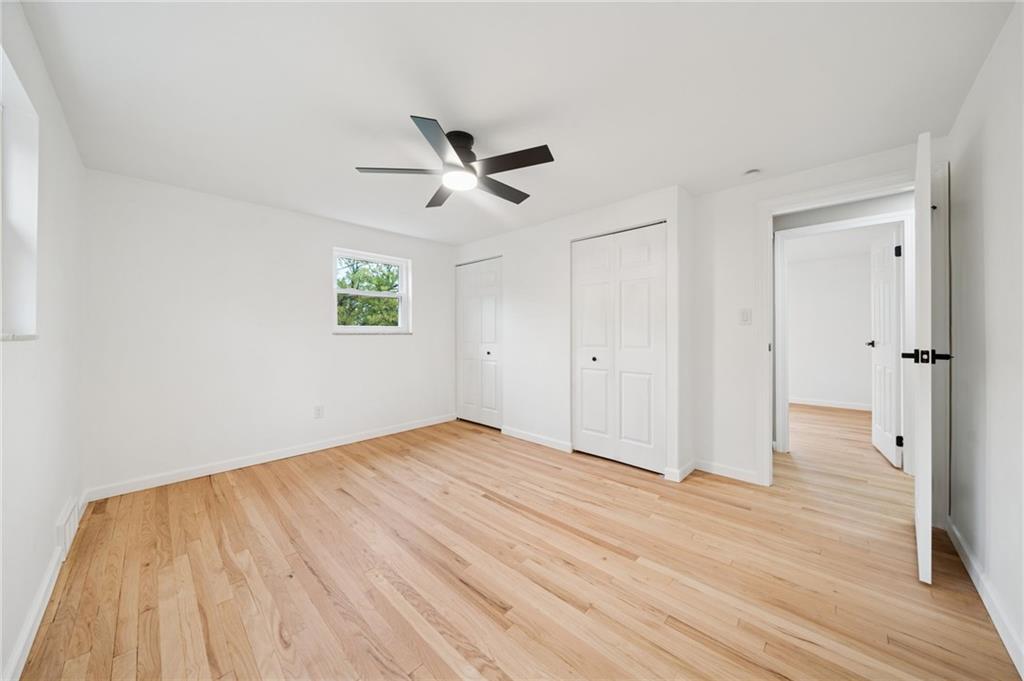 1714 O'Block Road Pittsburgh, PA 15239 - Photo 24 of 36 a view of empty room with wooden floor and ceiling fan