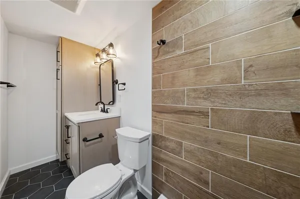 a bathroom with a toilet a sink and mirror