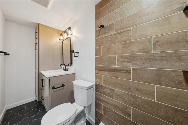 a bathroom with a toilet a sink and mirror