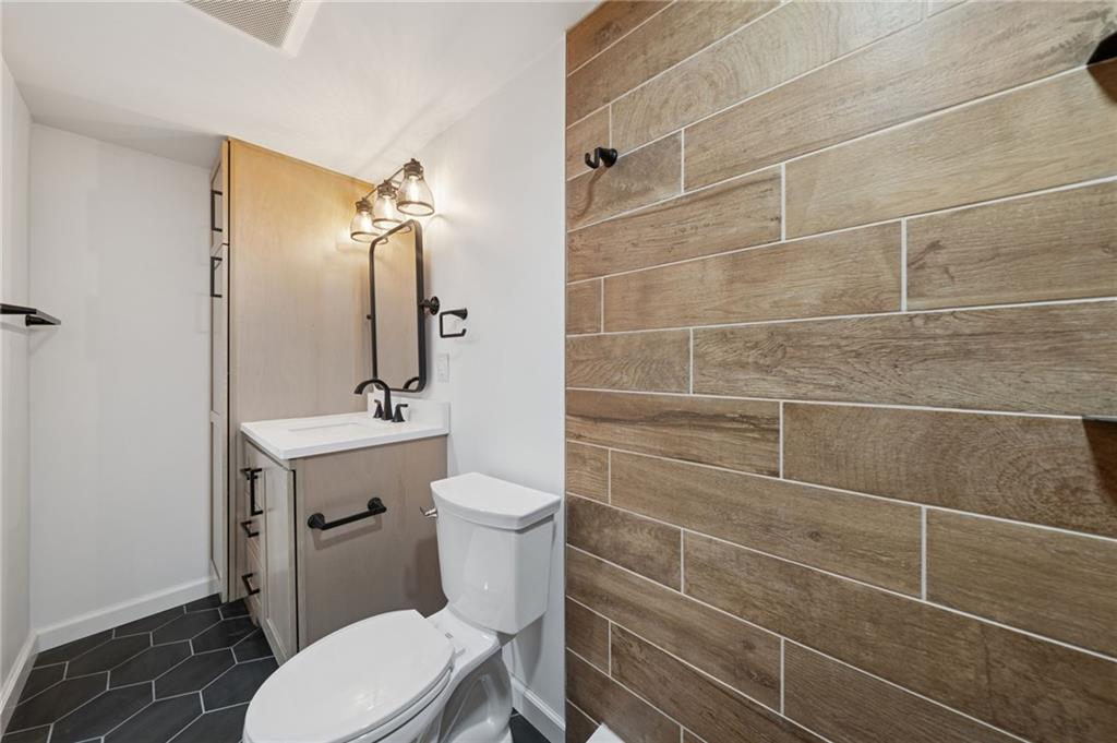 1714 O'Block Road Pittsburgh, PA 15239 - Photo 29 of 36 a bathroom with a toilet a sink and mirror