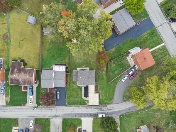 an aerial view of multiple houses with yard