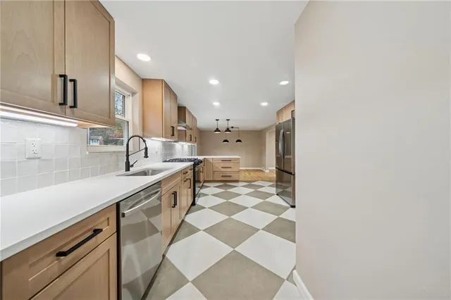 a large kitchen with a sink and cabinets