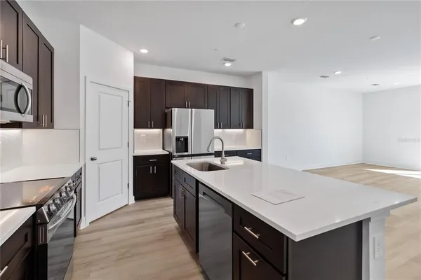a kitchen with a stove a refrigerator and a sink