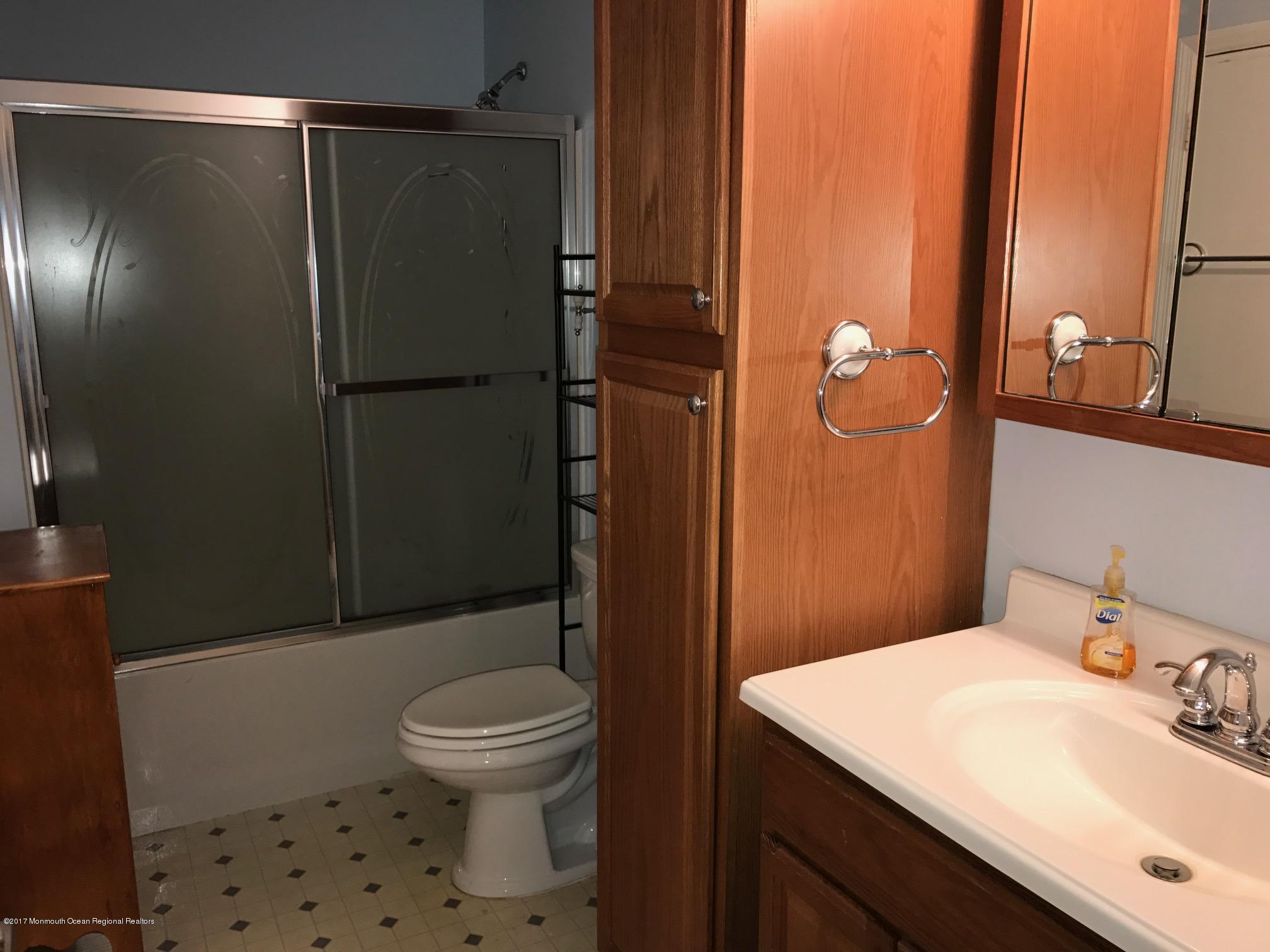 61 Korman Road Bayville, NJ 08721 - Photo 8 of 10 a bathroom with a sink a toilet and shower