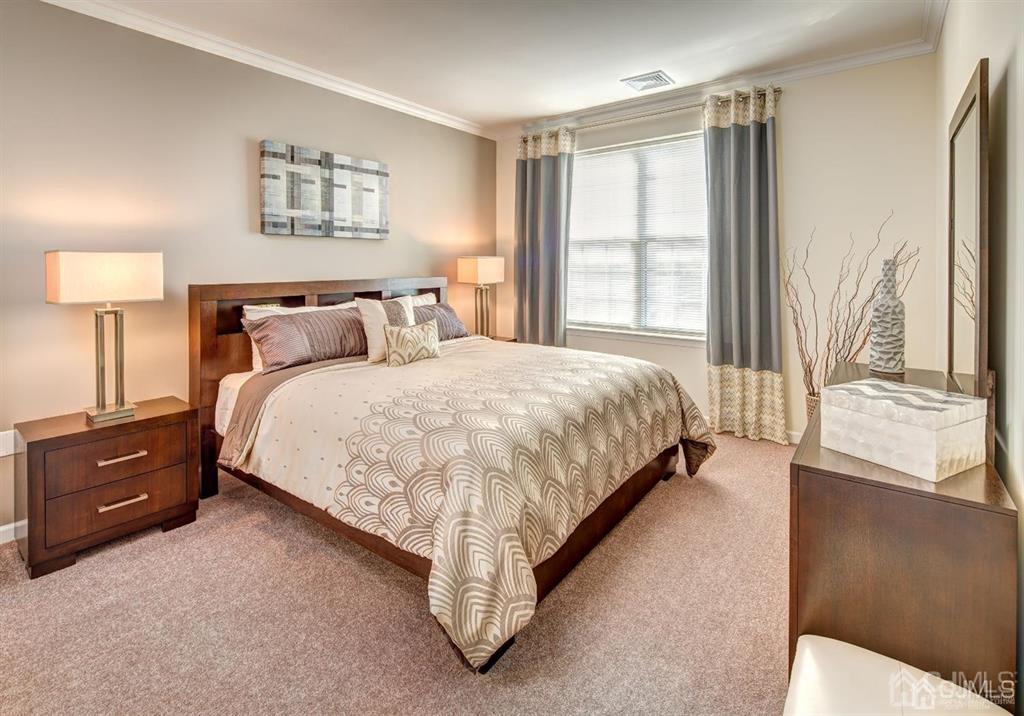 125 West Main Street, Unit 316 Somerville, NJ 08876 - Photo 14 of 17 a bedroom with a bed and a night stand