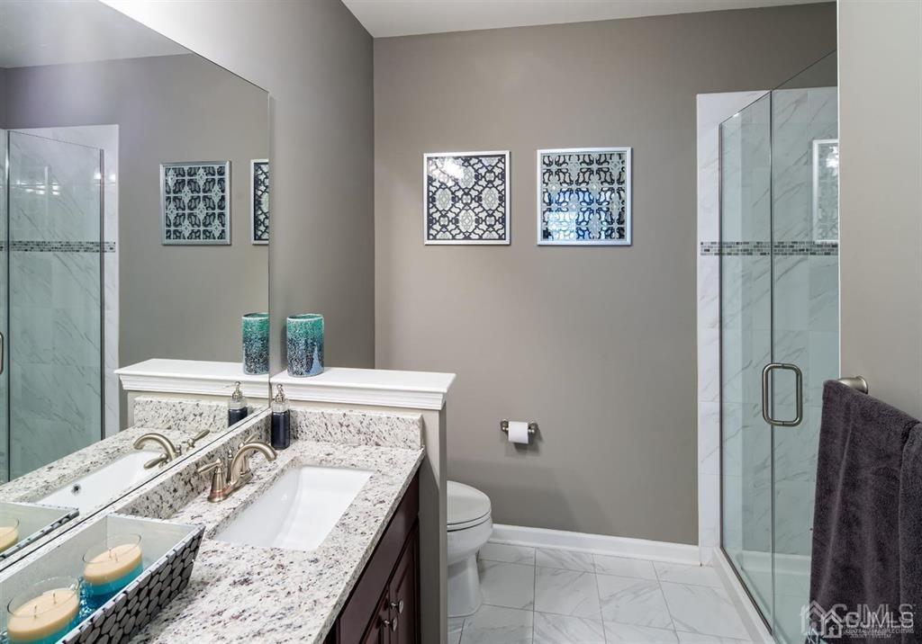 125 West Main Street, Unit 316 Somerville, NJ 08876 - Photo 15 of 17 a bathroom with a granite countertop sink a toilet and shower