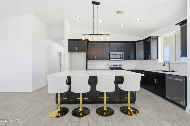 a kitchen with furniture a sink cabinets and appliances