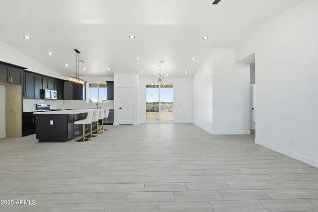 a large white kitchen with a large window