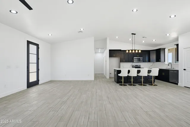 a kitchen with a sink and chairs