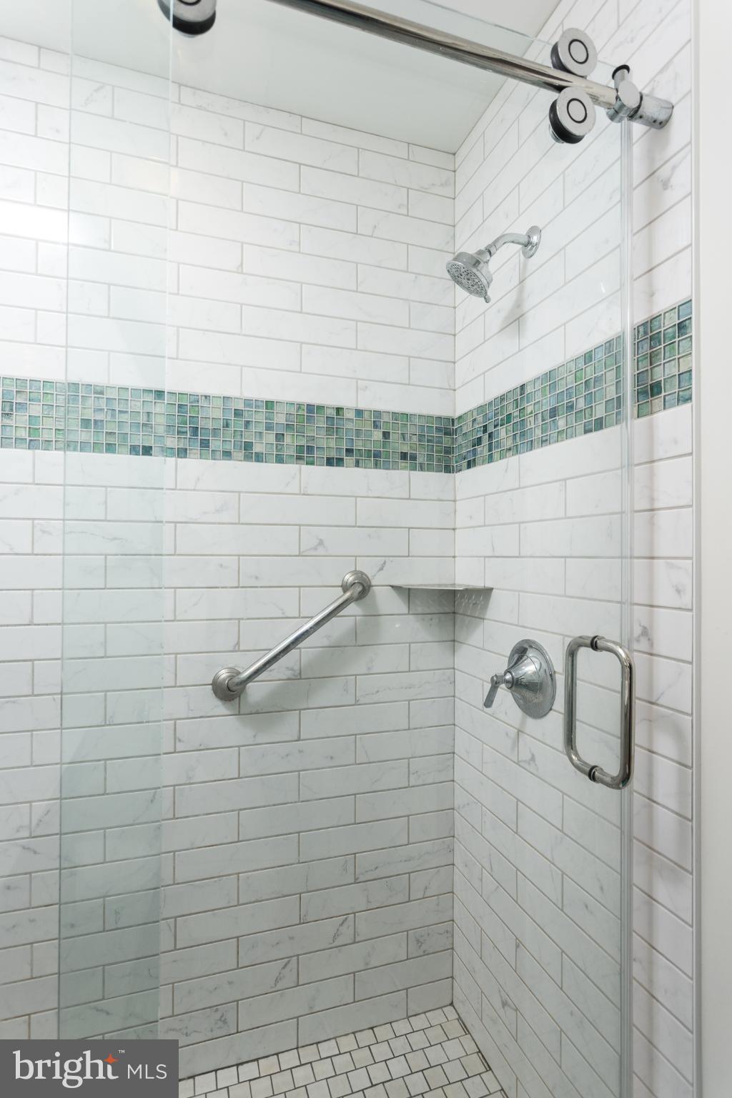 625 Dunkirk Road Baltimore, MD 21212 - Photo 16 of 39 Sleek, modern shower with elegant tile accents.