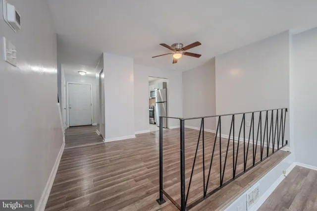 a view of hallway with wooden floor