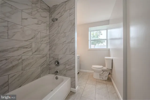 a bathroom with a toilet and a bathtub
