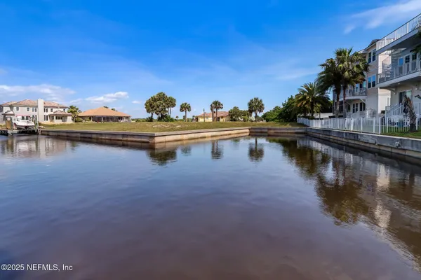 a view of swimming pool with outdoor seating and lake view