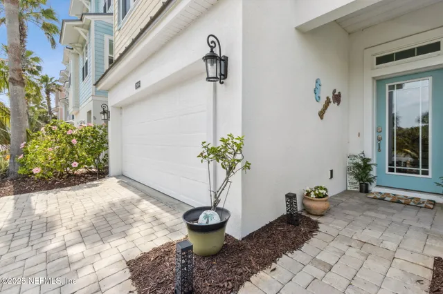 a living room with furniture kitchen view and a flat screen tv