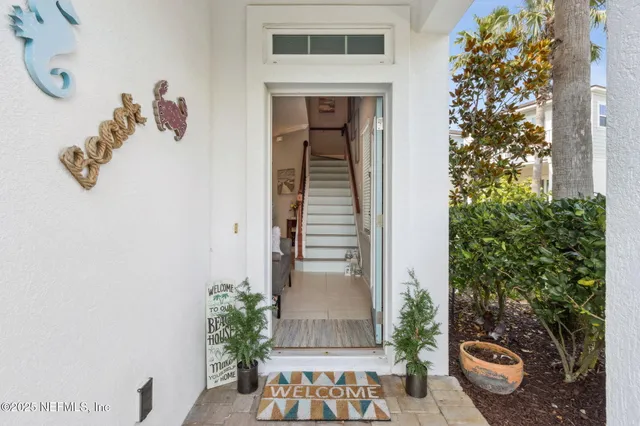 a kitchen with stainless steel appliances a dining table chairs sink and cabinets