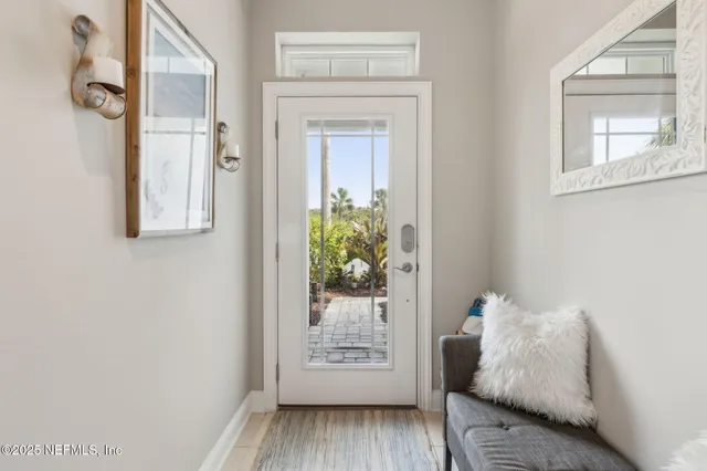 a kitchen with stainless steel appliances granite countertop a stove top oven a sink dishwasher a dining table and chairs with wooden floor